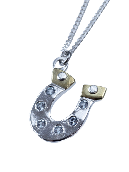 Lucky You sterling silver and brass horseshoe pendant with clear CZ gemstones