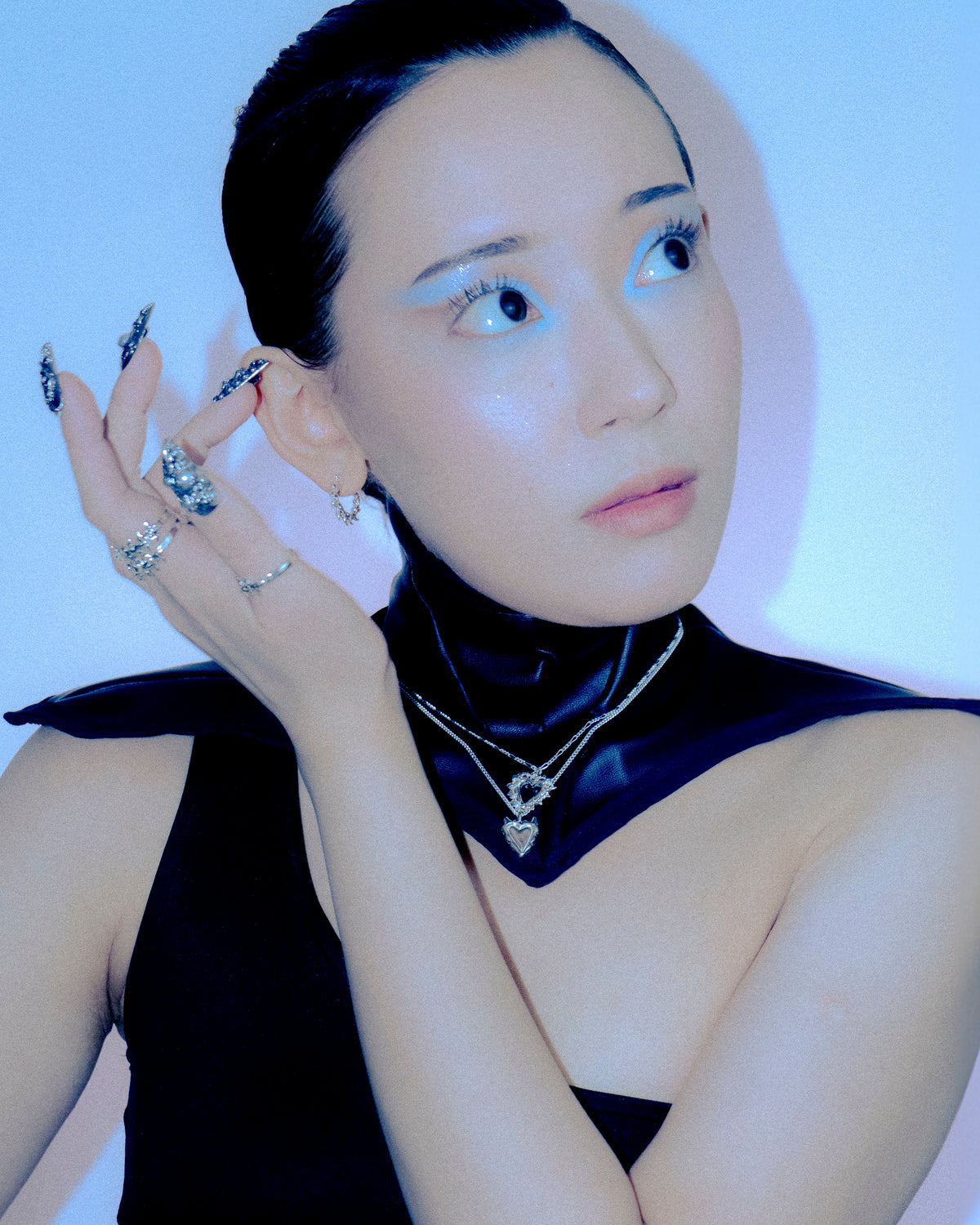 Model wearing Thorny Hoops in a blue-lit editorial portrait