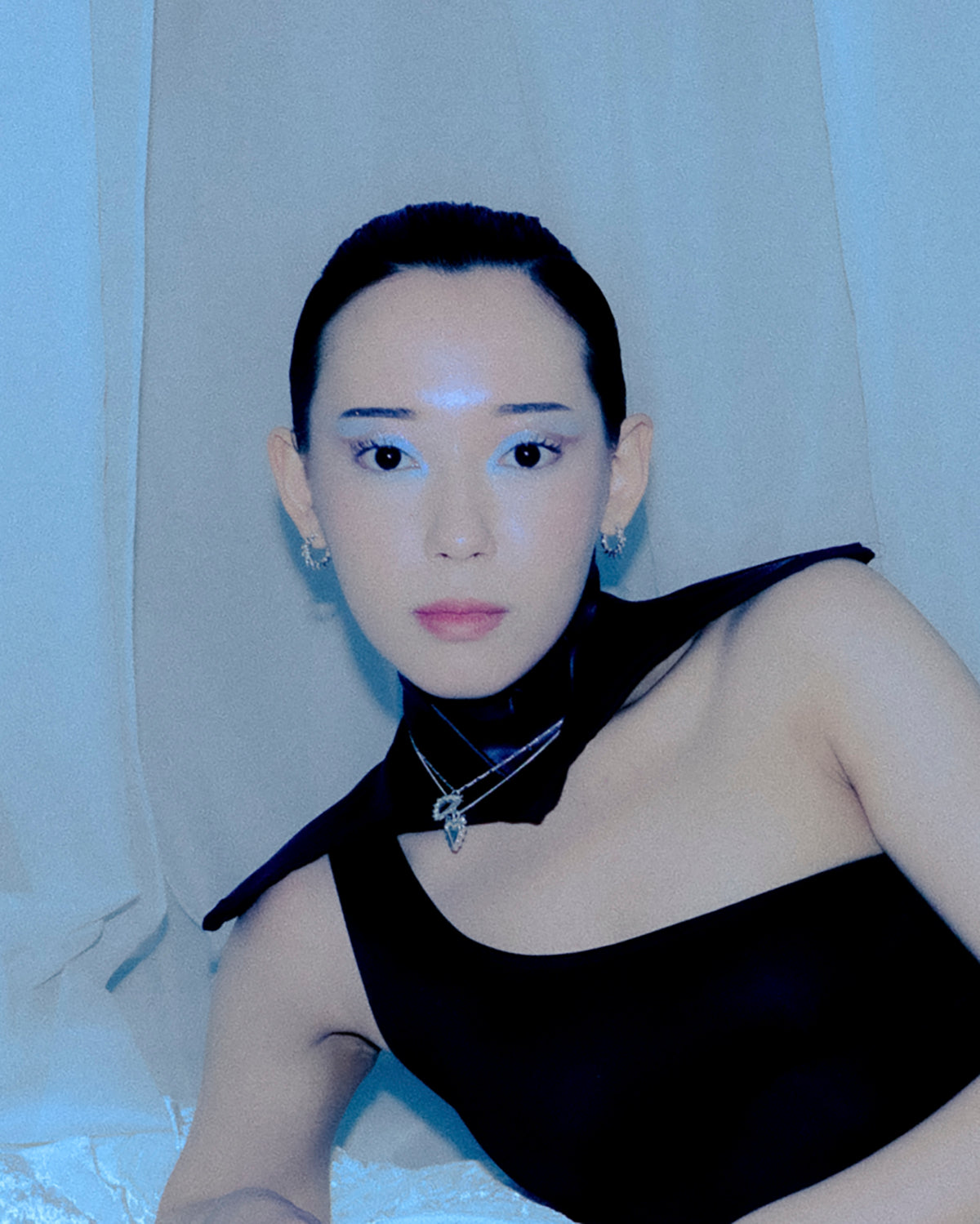 Front view of a model wearing Thorny sterling silver hoop earrings