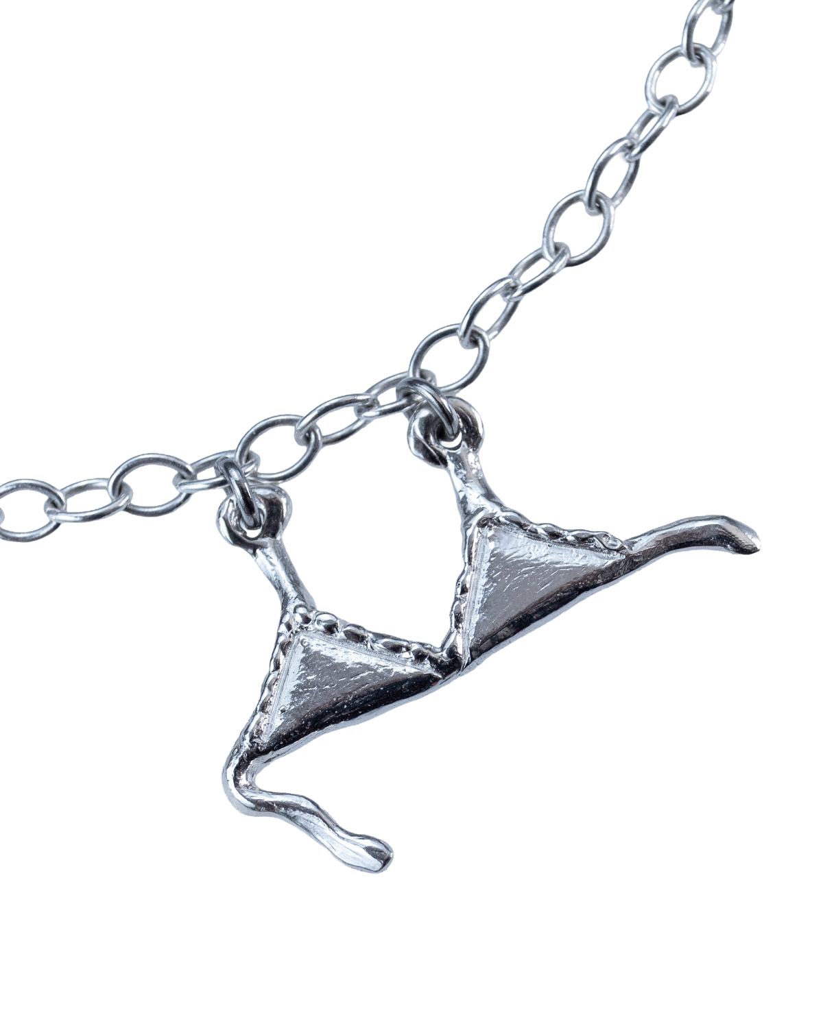 Close-up of a sterling silver bra charm on the Clothesline necklace