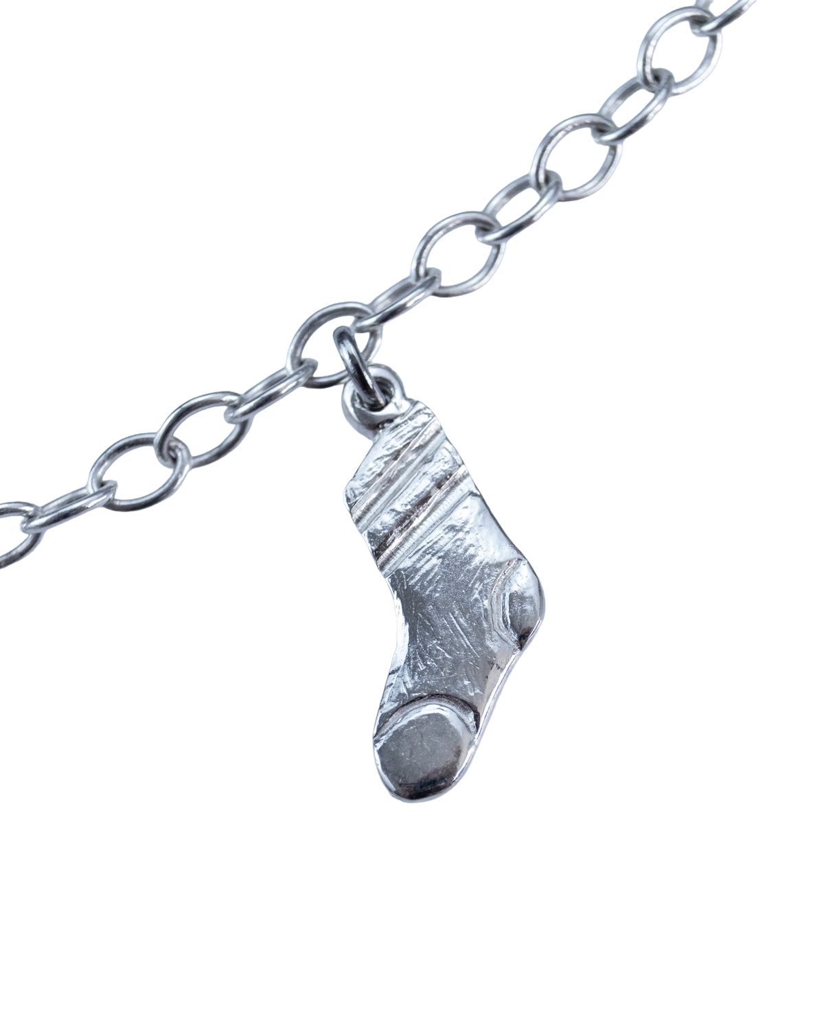 Close-up of a sterling silver sock charm on the Clothesline necklace