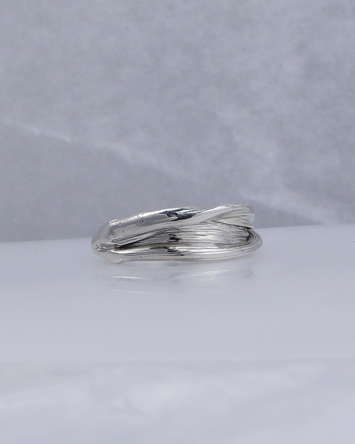 Side view showing the layered folds of the Fold 005 sterling silver ring