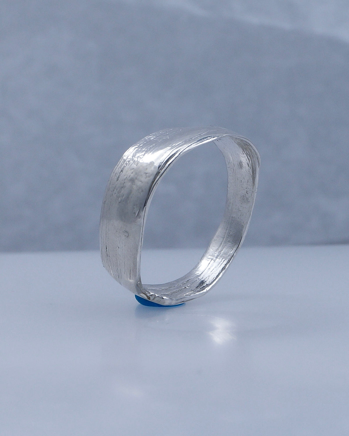 Side view showing the wide folded band of the Fold 004 sterling silver ring