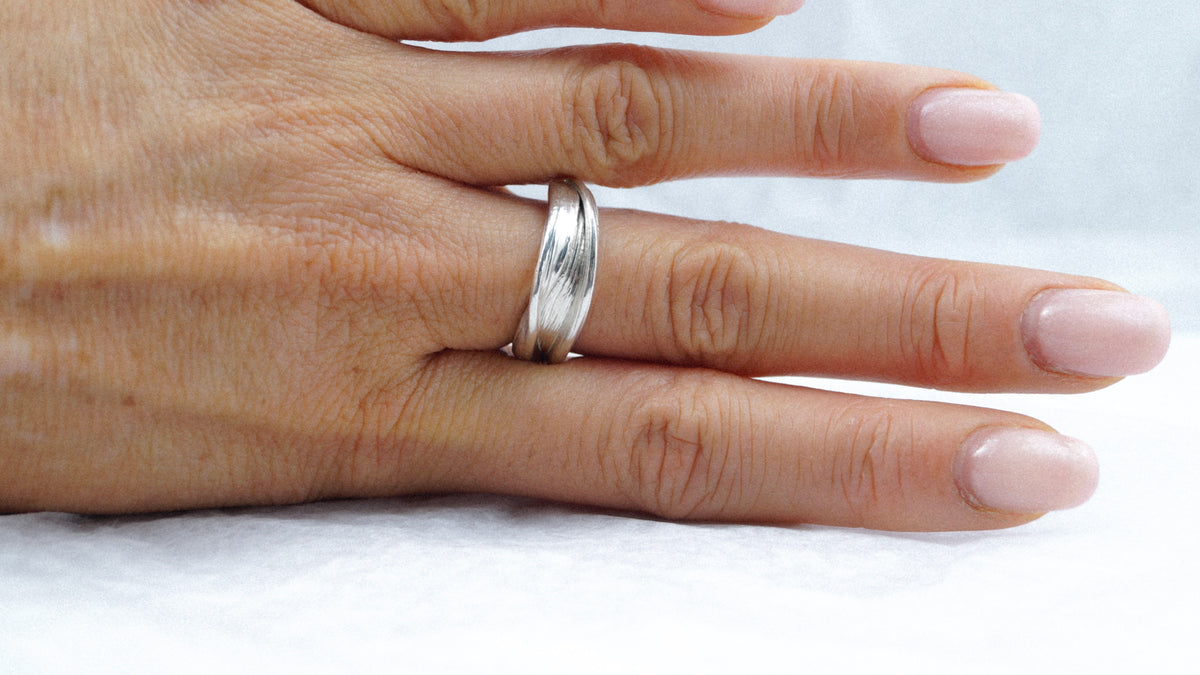 Hand wearing the Fold 005 sculptural sterling silver ring