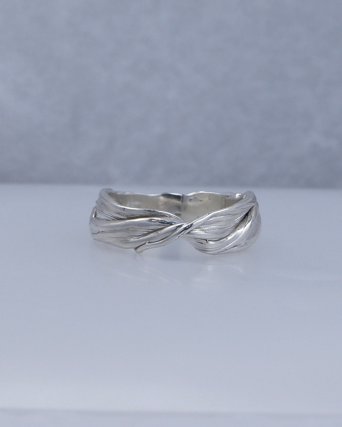 Fold 006 sterling silver ring photographed on a pale surface