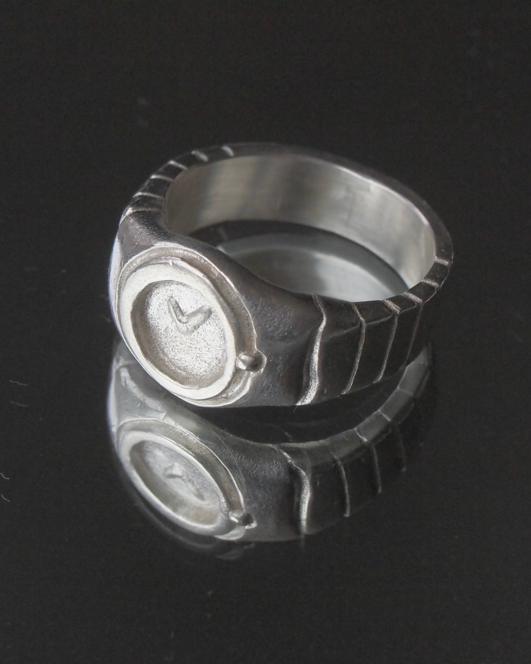 11:11 sterling silver watch ring reflected on a black surface