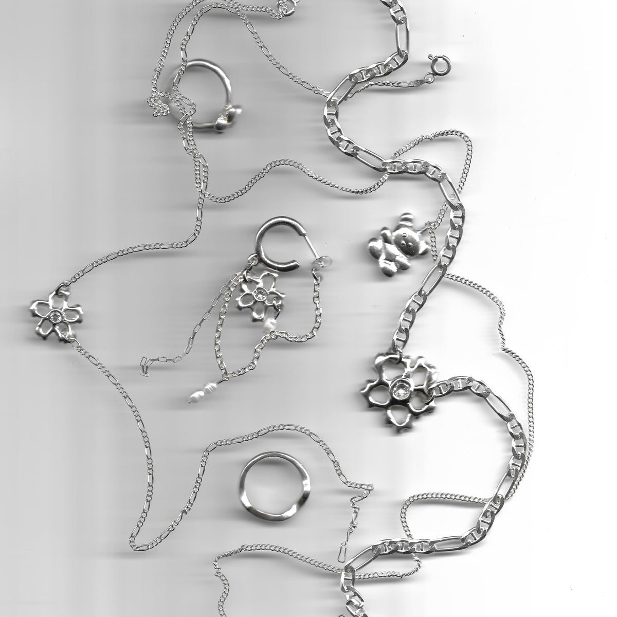 Baby Daisy Chain and Daisy Chain layered with silver necklaces