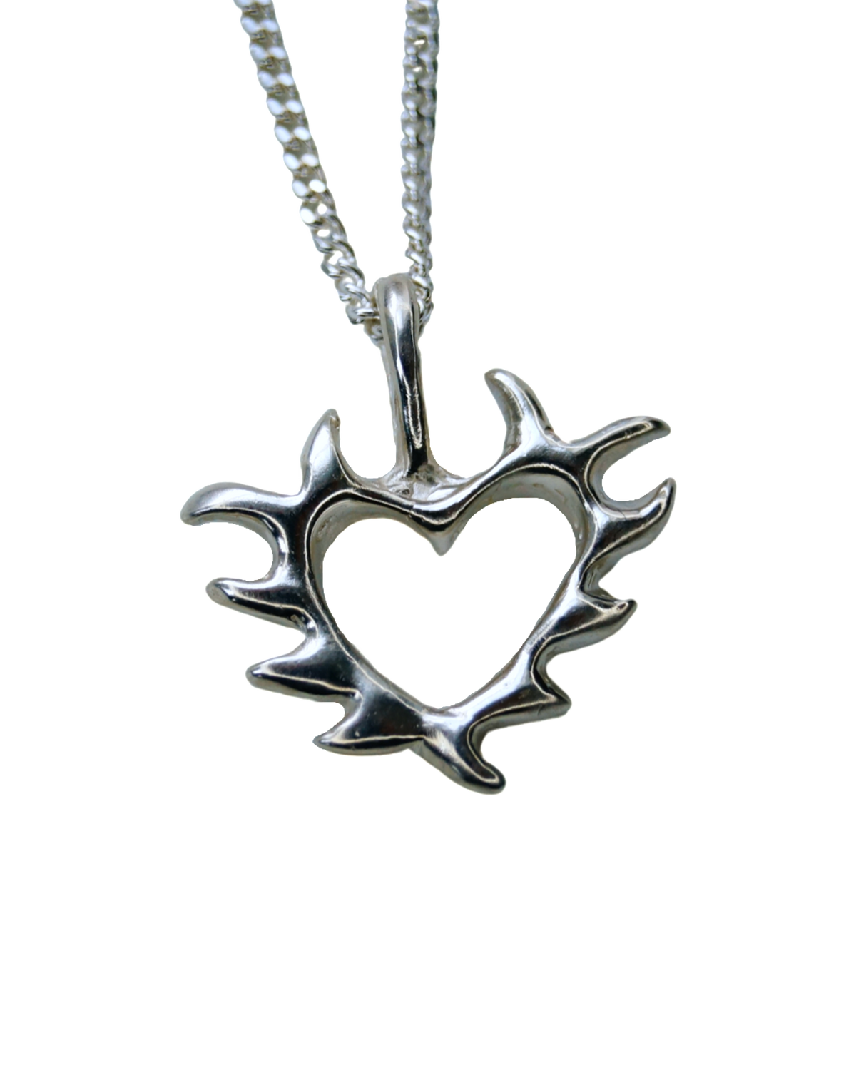 close up of a silver heart shaped pendant, with negative space in centre that is on a silver chain
