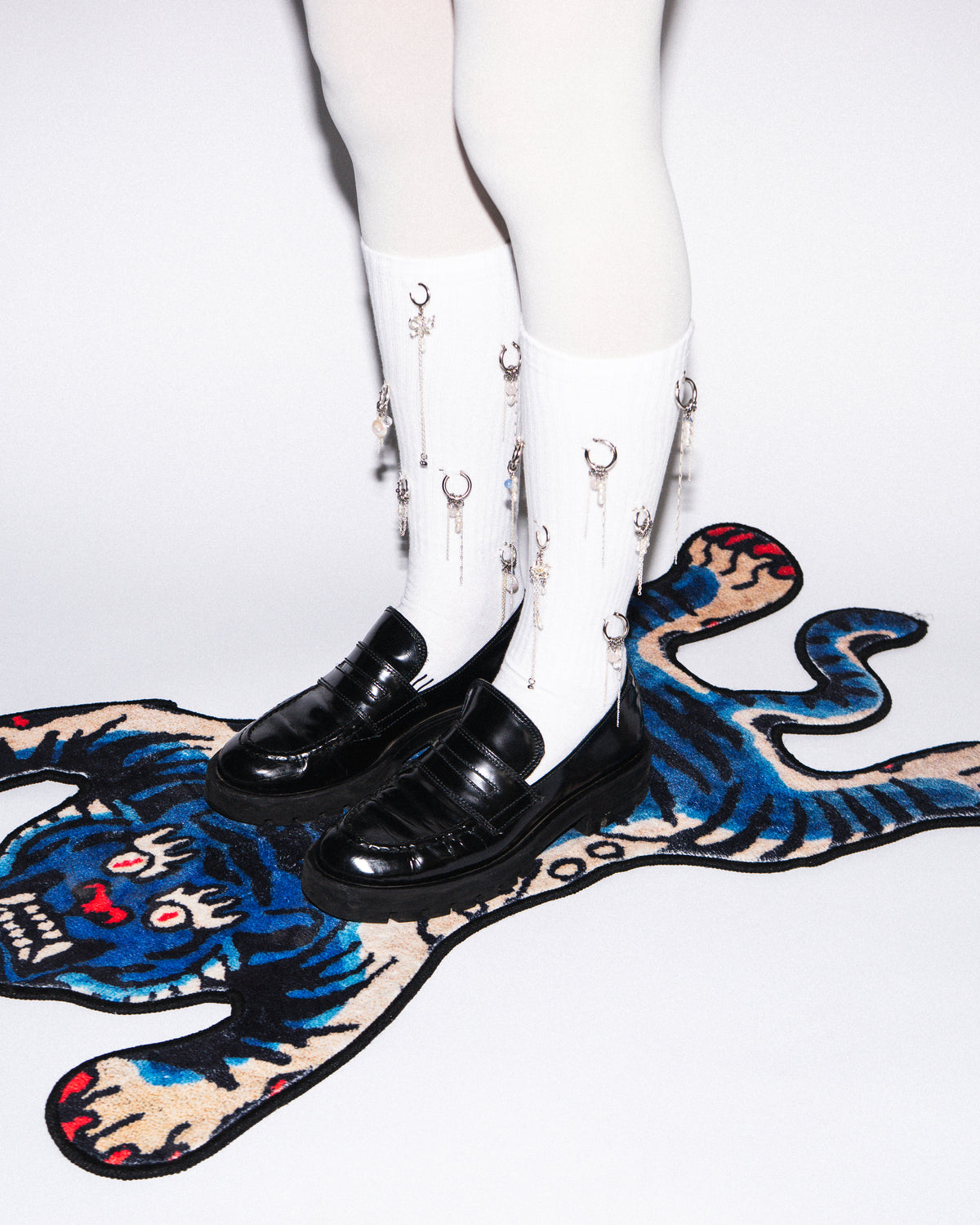 Bicoastal sculptural earrings styled on a model