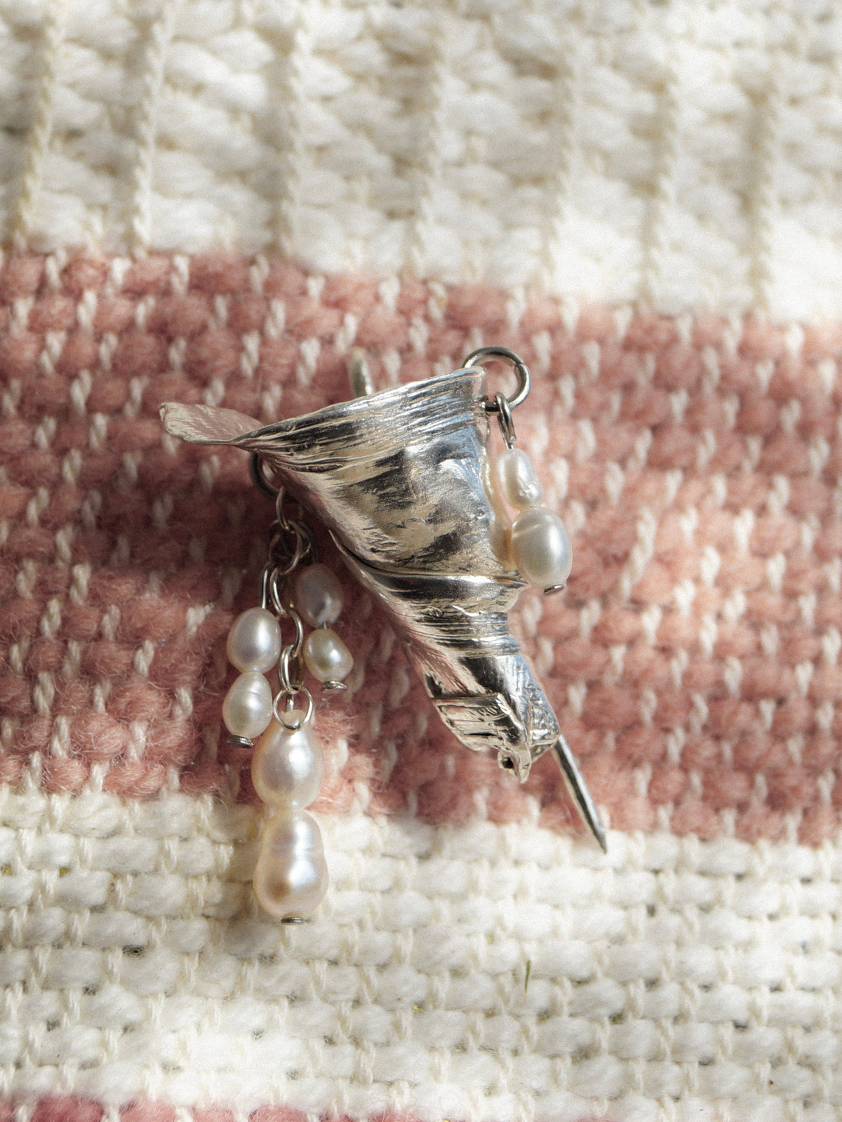 Angled view of the Bouquet sterling silver brooch showing its pin and pearl drops