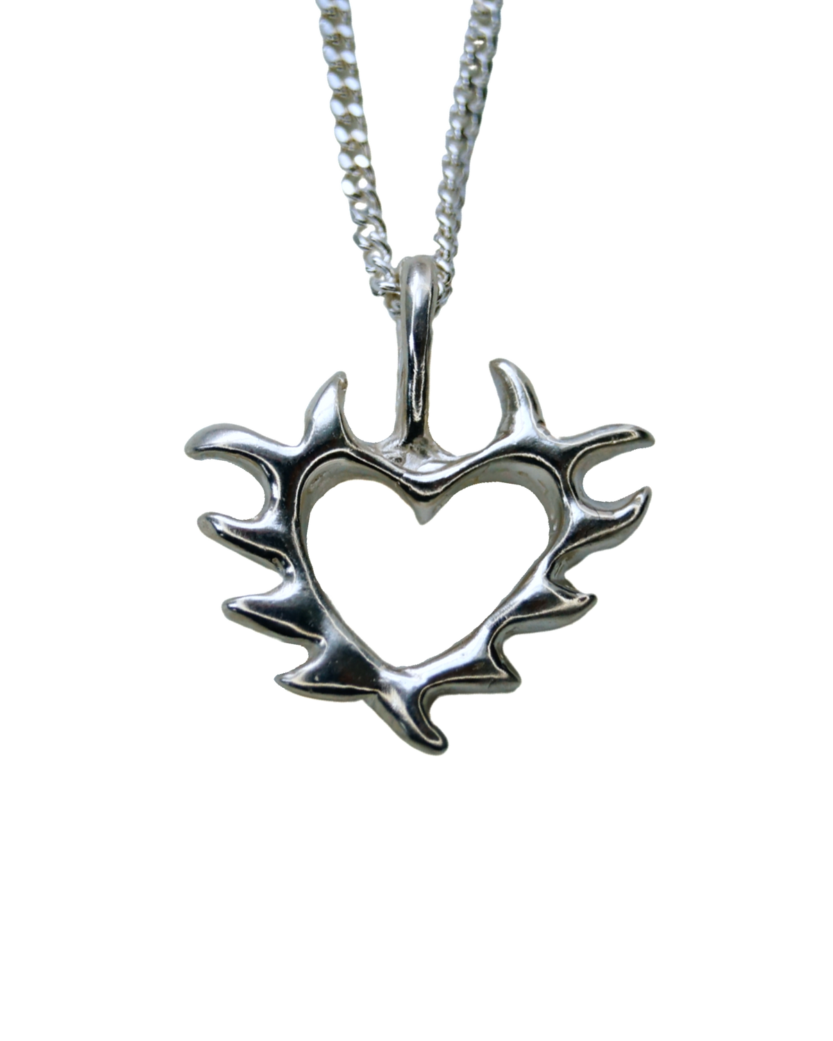 A silver pendant with a tattoo-inspired open heart design attached to a silver chain.