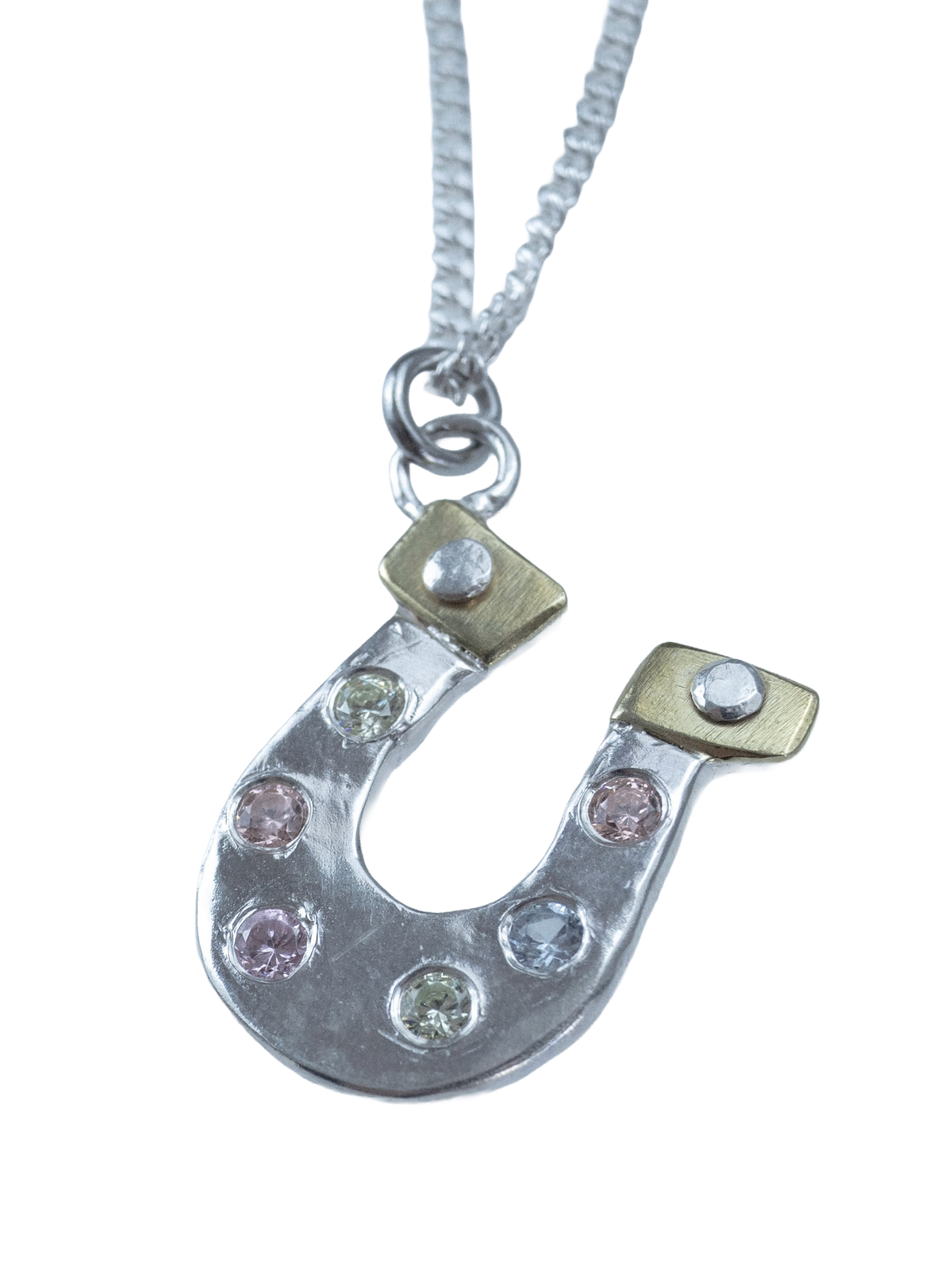 Close-up of Lucky You mixed-metal horseshoe necklace on a silver chain