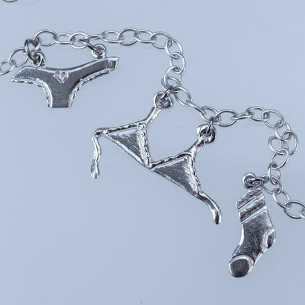 sterling Silver underwear-themed charm necklace on a light gray background