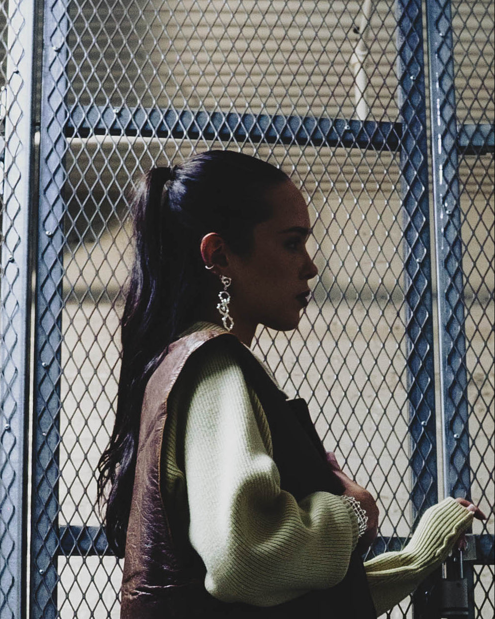 Model wearing Fluid Wave sculptural sterling silver statement earrings