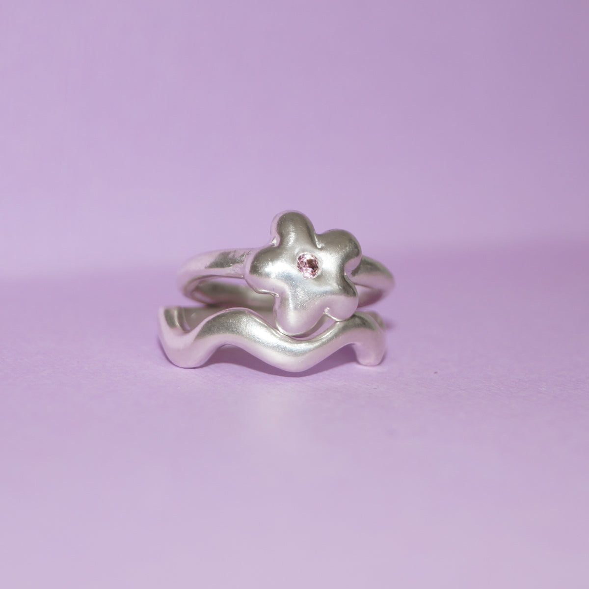 Daisy Ring worn on the hand with other silver rings