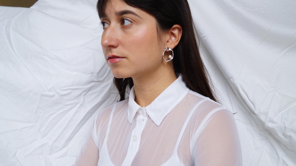 Daughter pearl earrings styled at the ear