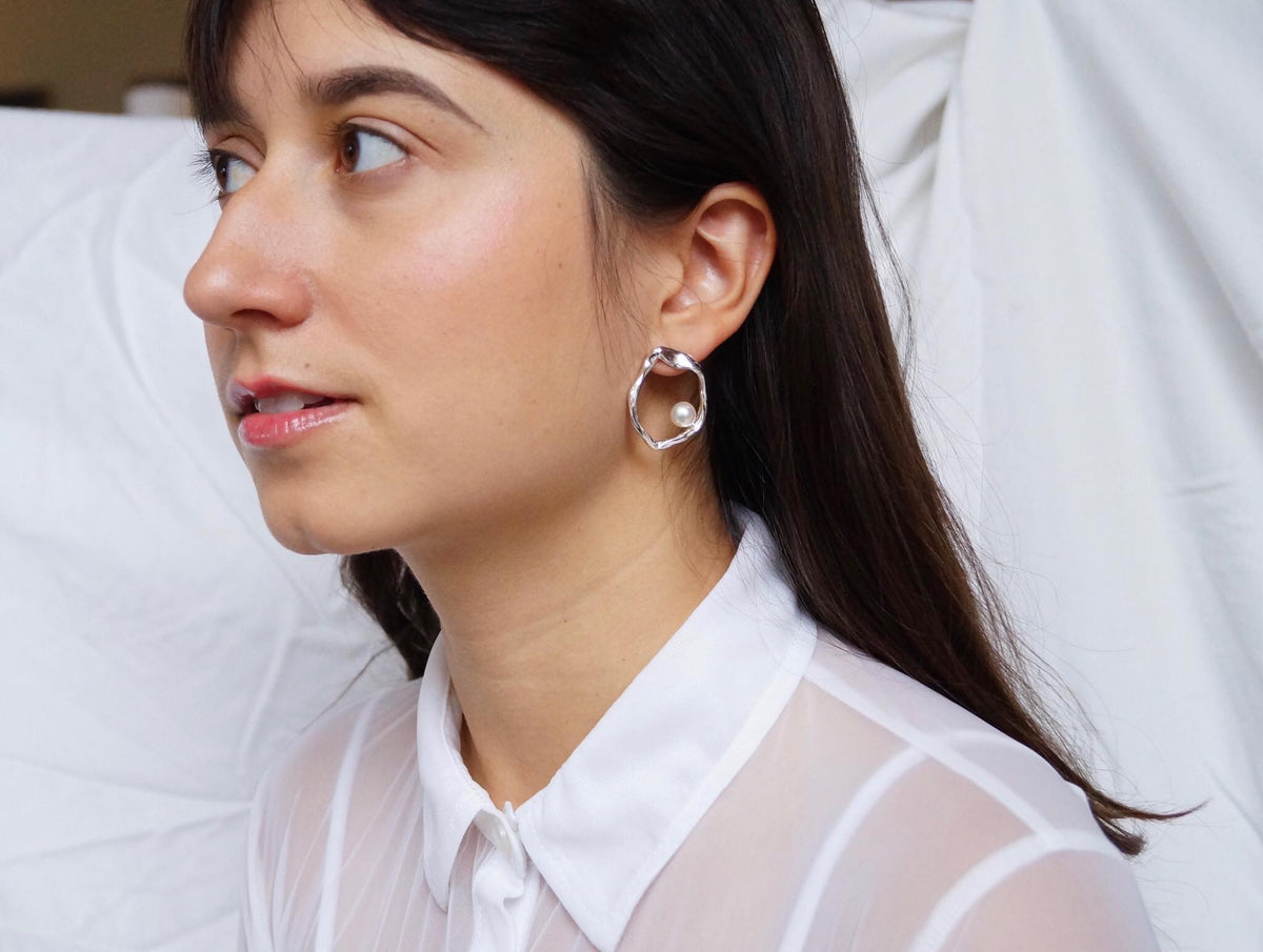 Close-up of sterling silver earrings with freshwater pearls