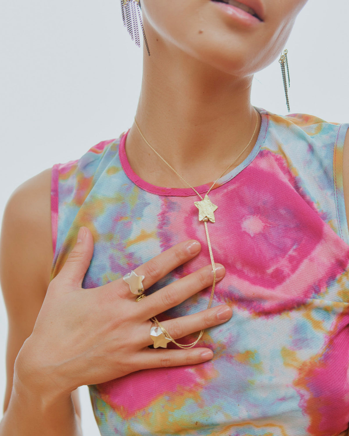 Star Signet rings styled with a silver star necklace on a model