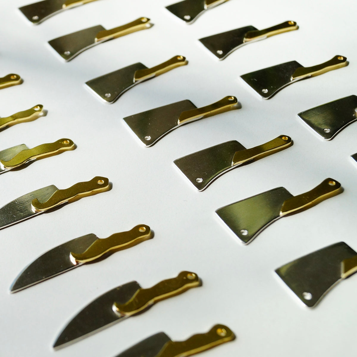Close-up of the sterling silver blade and brass handle pendant